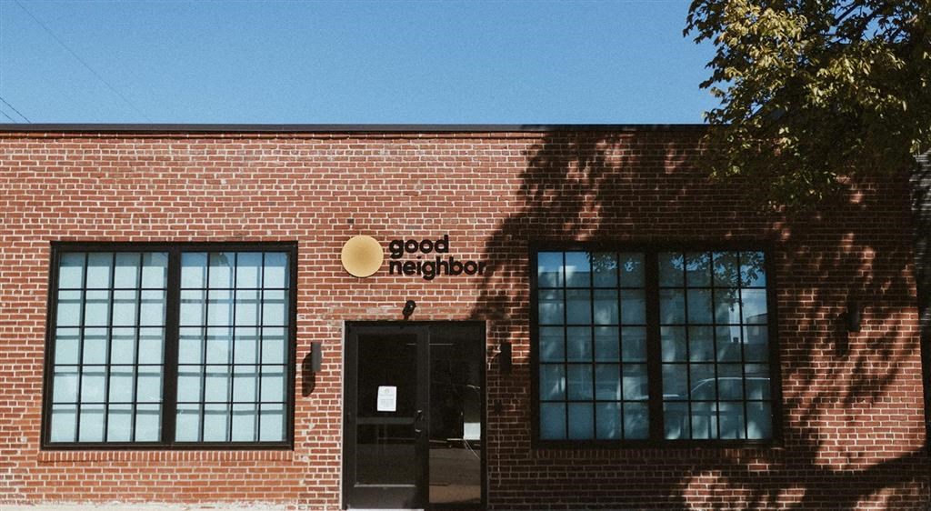 a brick building with two windows and a door