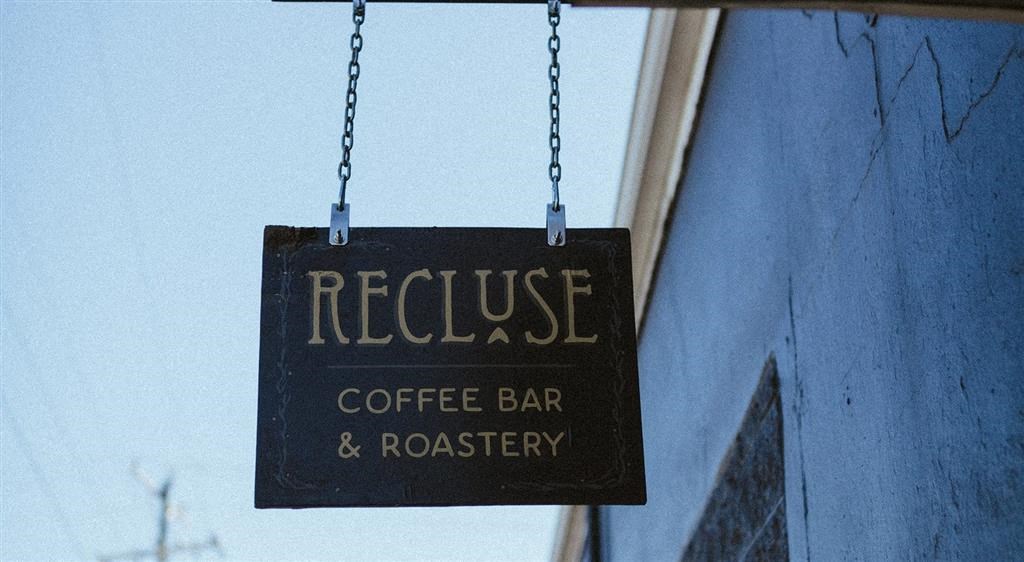 a sign hanging from the side of a building