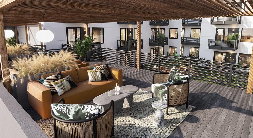 a view of the patio area of the hotel with couches and tables