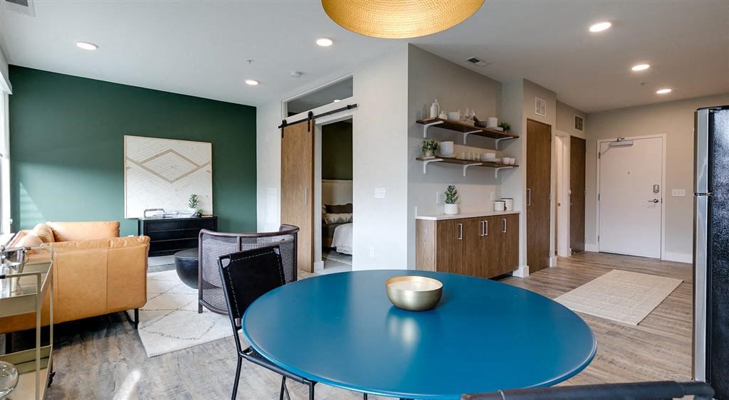 a dining room with a blue table and chairs