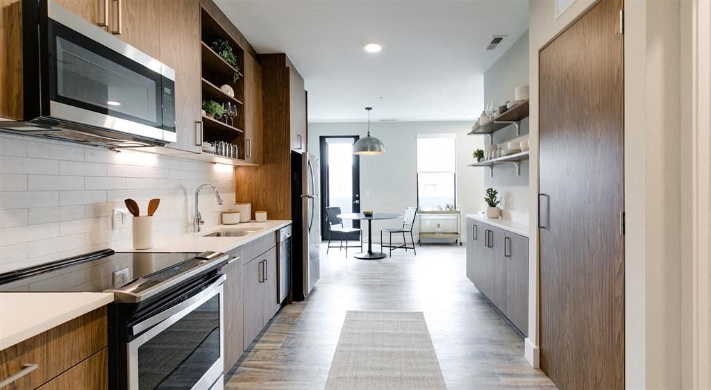 a kitchen with a stove top oven next to a microwave