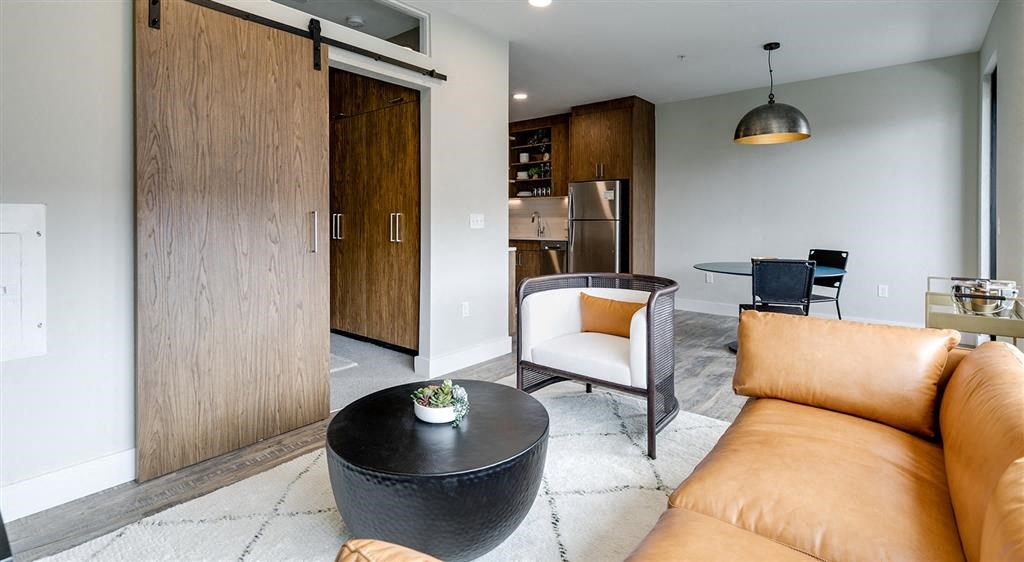 a living room with a leather couch and a coffee table
