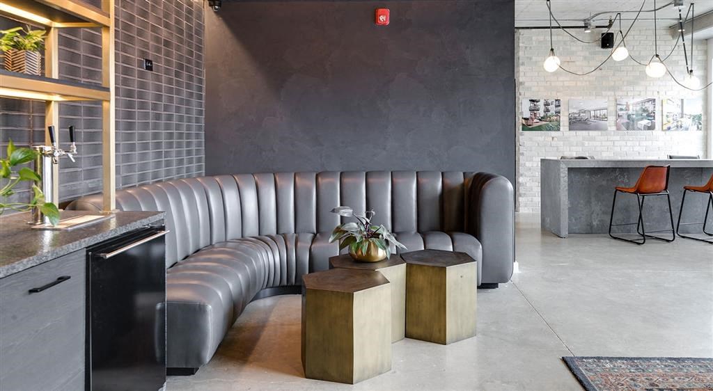 a room with a couch and tables in it