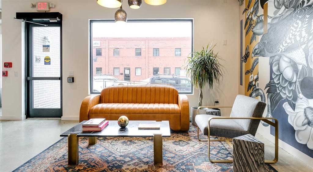 a living room with a couch and chair in front of a window