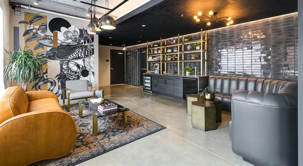 a living room filled with furniture and a large painting on the wall