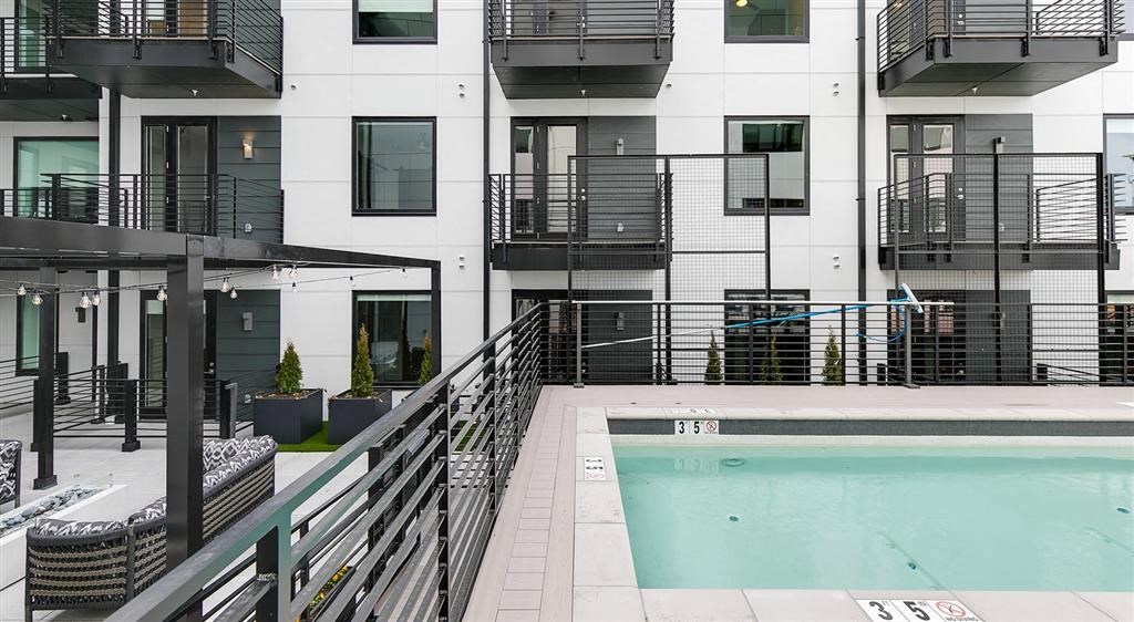 a pool is shown in front of an apartment building