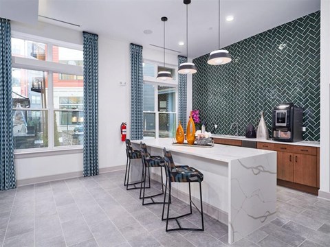 a kitchen with a marble counter top and bar stools
