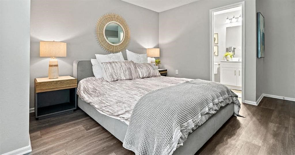 a bedroom with a bed and a mirror at Trails at Short Pump Apartments, Richmond
