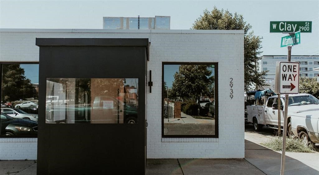 a white and black building with a street sign in front of it
