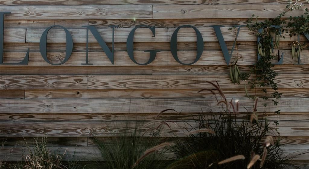 a sign that says lono on a wooden wall