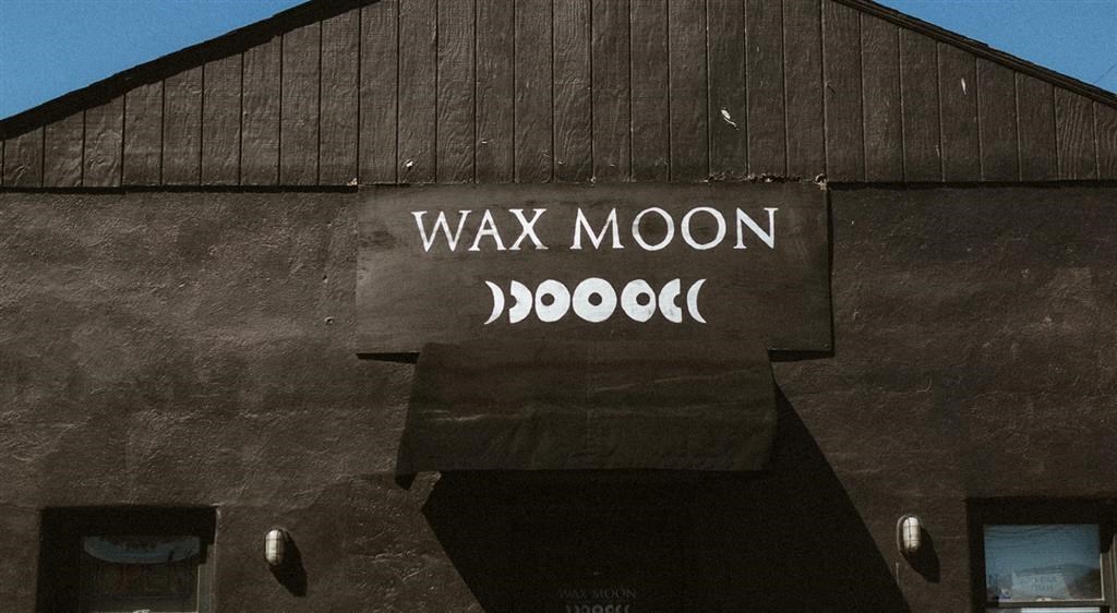a black barn with a sign that says wax moon