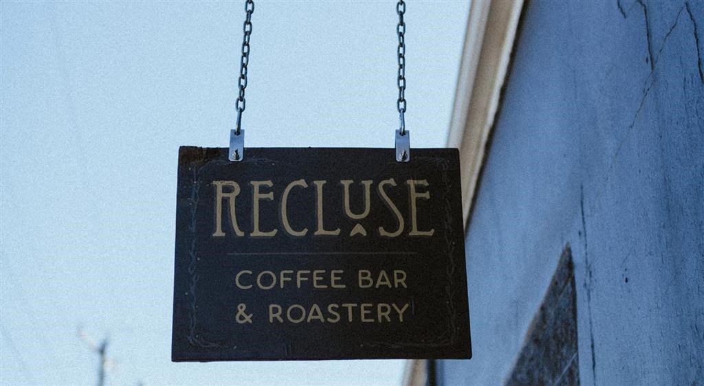 a sign that says recourse coffee bar and roaster