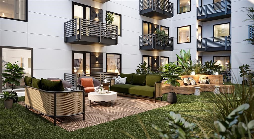 a living area with couches and chairs in front of a building