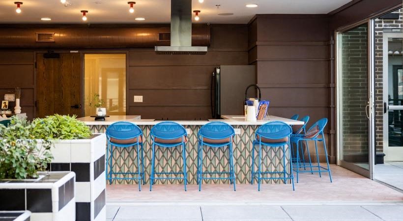 a kitchen with a bunch of blue chairs