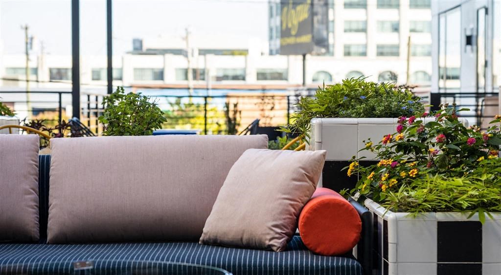 a couch with a pillow on a balcony