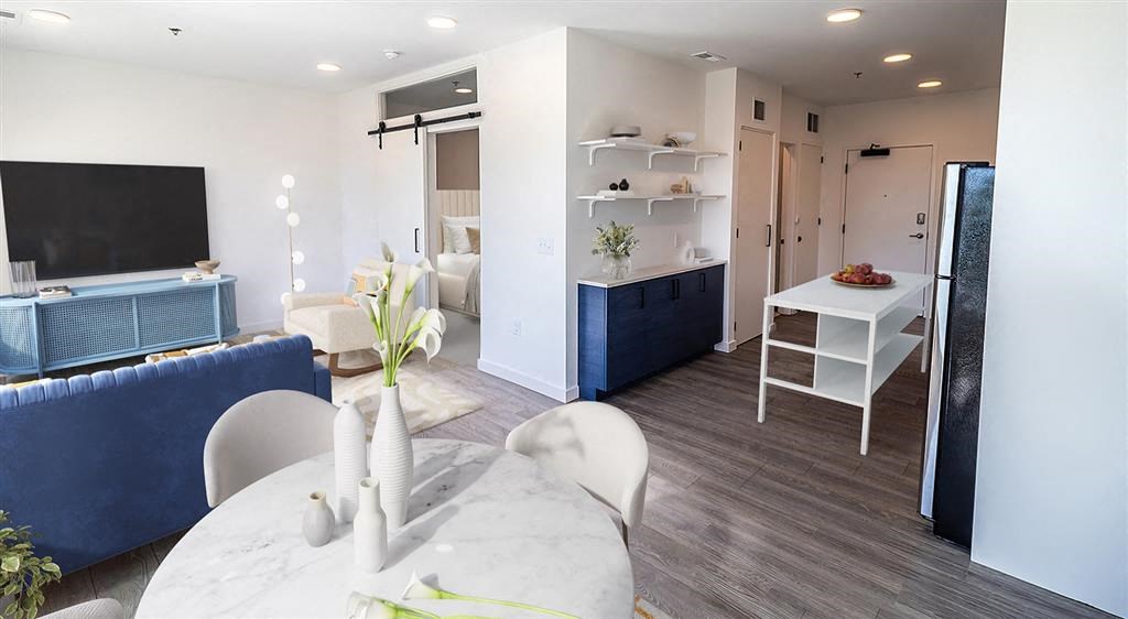 a kitchen and living room with a table and chairs