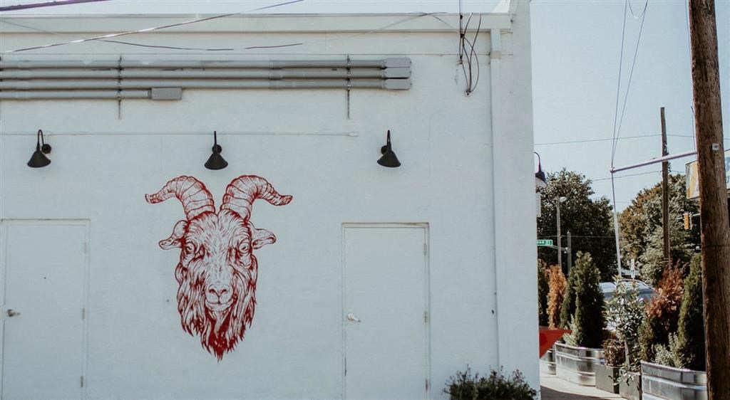 a painting of a ram on the side of a building
