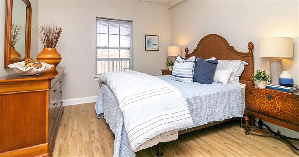 a bedroom with a bed and a dresser  at Saltmeadow Bay, Virginia Beach, VA