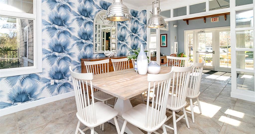 a dining room with a wooden table and white chairs  at Saltmeadow Bay, Virginia Beach, Virginia