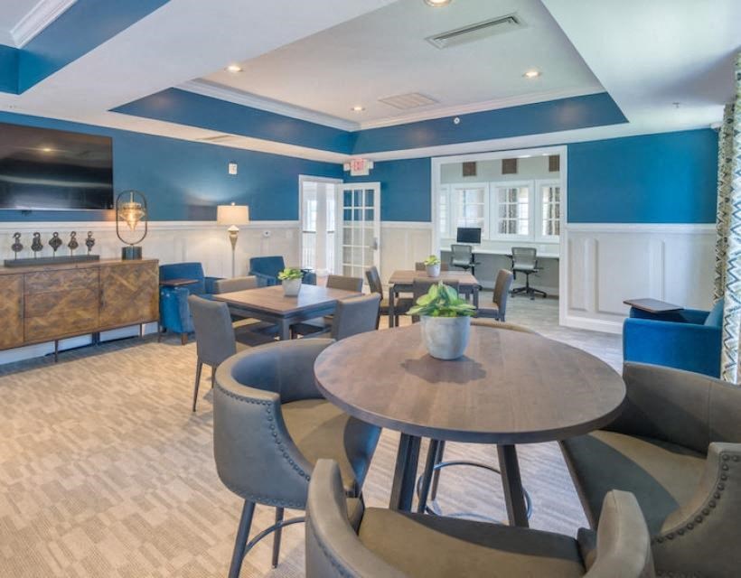 a large room with tables and chairs and a bar at Sterling Manor, Williamsburg, VA