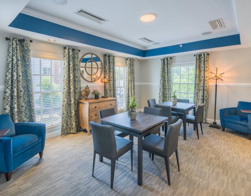 a room with a table chairs and a clock on the wall at Sterling Manor, Williamsburg