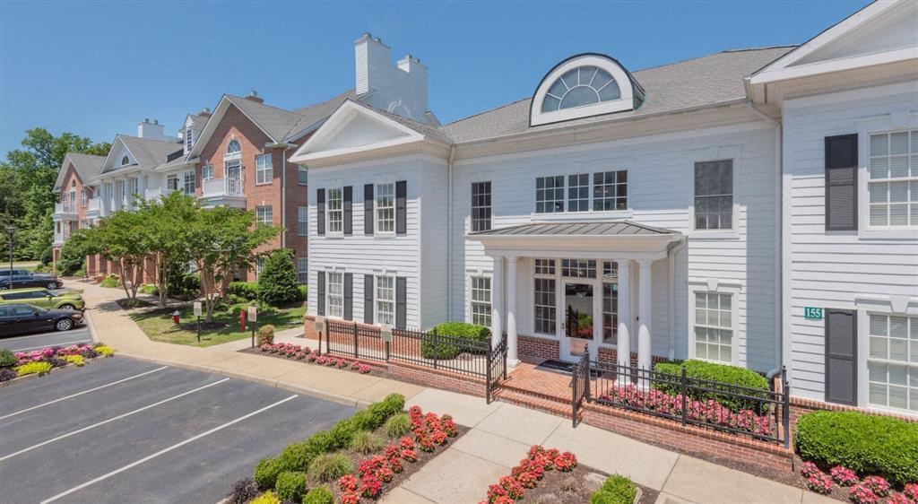a large white building with a black fence in front of it at Sterling Manor, Virginia ,23185