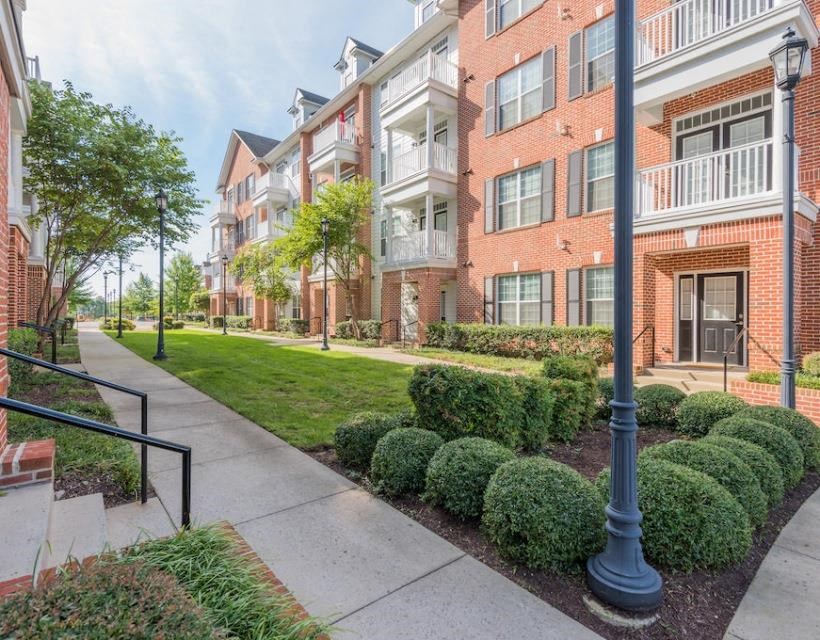 a large brick building with a grassy area in front of it at Sterling Manor, Williamsburg, 23185