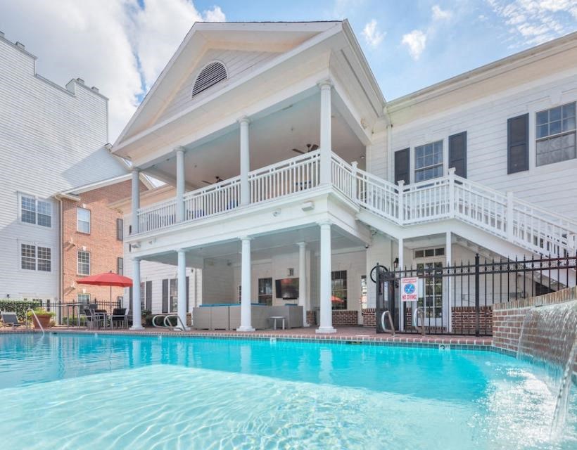 a large swimming pool in front of a white building at Sterling Manor, Williamsburg, VA 23185