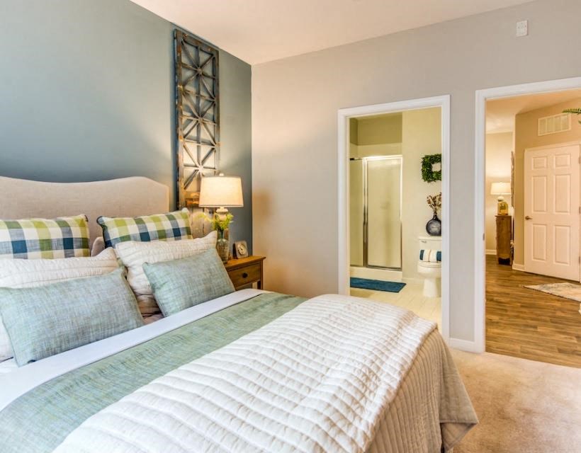 a bedroom with a bed and a door to a bathroom at Sterling Manor, Williamsburg, VA
