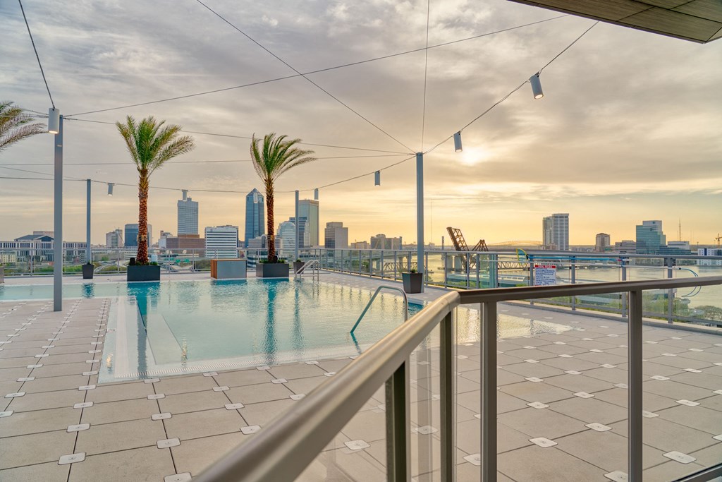 the swimming pool on the roof of a building with the city skyline in the background the swimming pool on the roof of a building with the city skyline in the background at Vista Brooklynn Apartments, Florida
