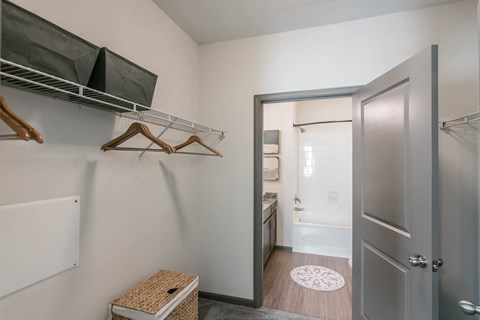a walk in closet with a door to the bathroom and a closet door to a at Village at Westland Cove Apartments, Knoxville, TN
