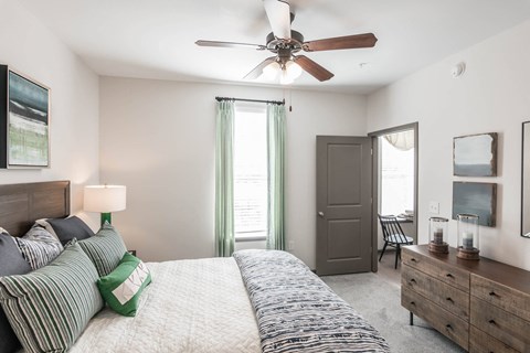 a bedroom with a bed and a ceiling fan at Village at Westland Cove Apartments, Tennessee, 37922