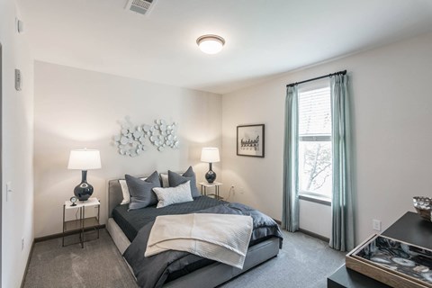 a bedroom with a large bed and a window at Village at Westland Cove Apartments, Tennessee