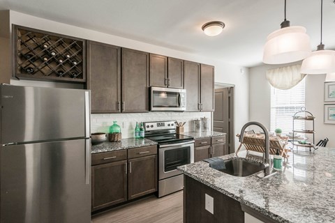 a kitchen with stainless steel appliances and granite counter tops at Village at Westland Cove Apartments, Knoxville, TN, 37922