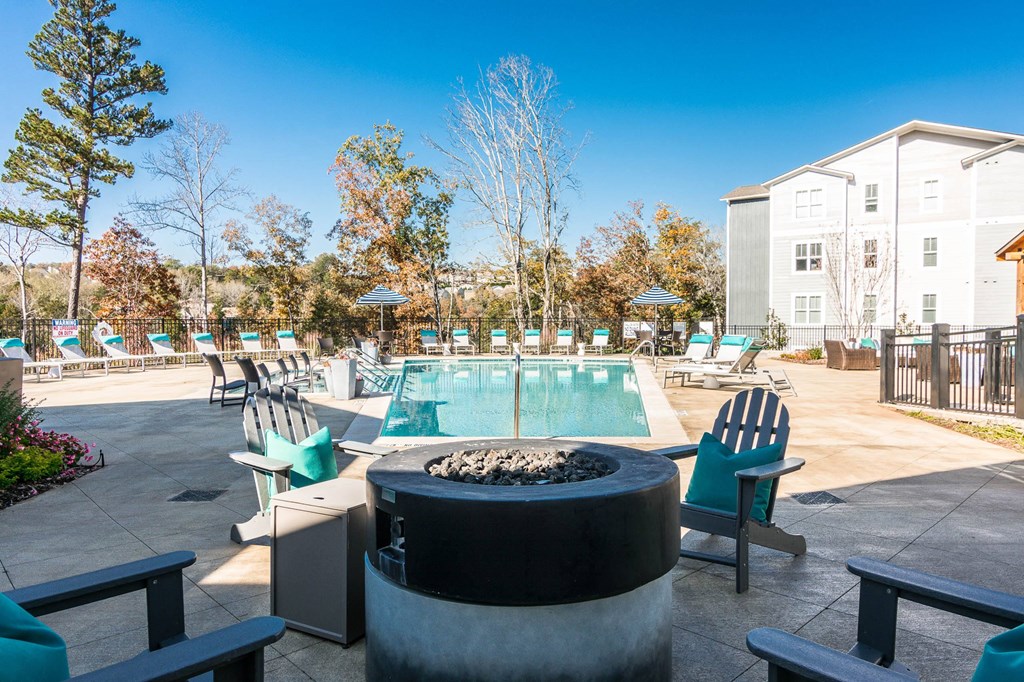 our apartments have a resort style pool and lounge area with chairs at Village at Westland Cove Apartments, Tennessee