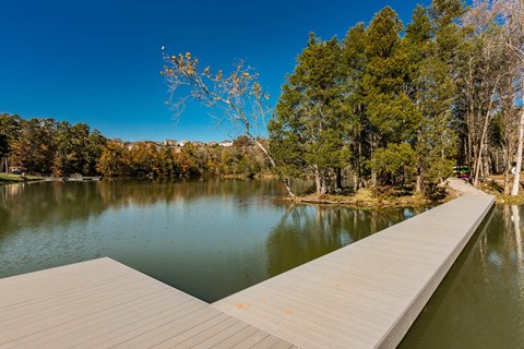 a dock on a lake with trees in the background at Village at Westland Cove Apartments, Knoxville, 37922