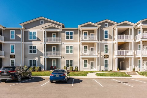 an apartment building with cars parked in front of it at Village at Westland Cove Apartments, Knoxville, 37922