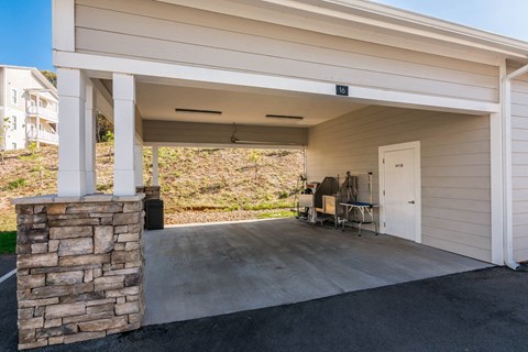 a covered porch with a door and a table on it at Village at Westland Cove Apartments, Tennessee