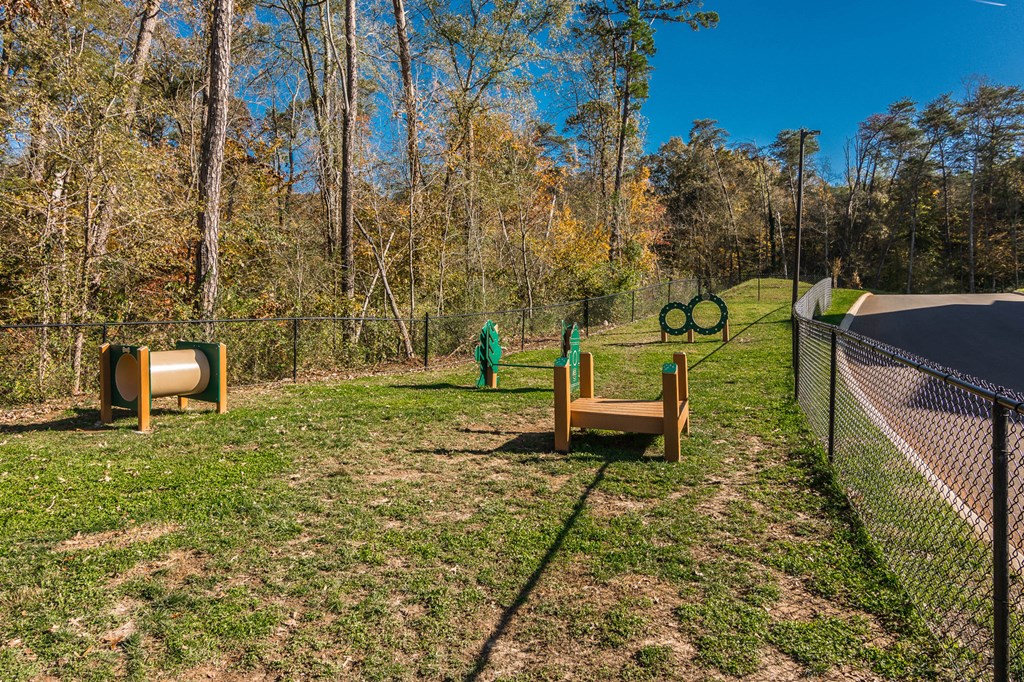 a dog park with agility equipment and a fence at Village at Westland Cove Apartments, Tennessee