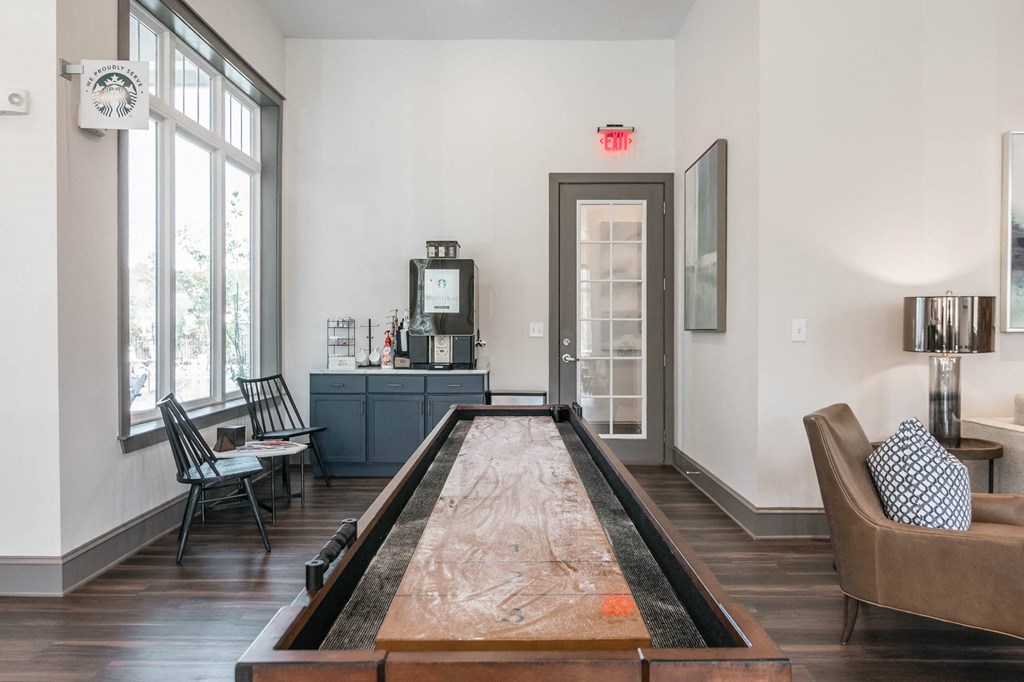 the living room has a shuffleboard table in the middle of it at Village at Westland Cove Apartments, Knoxville, TN, 37922
