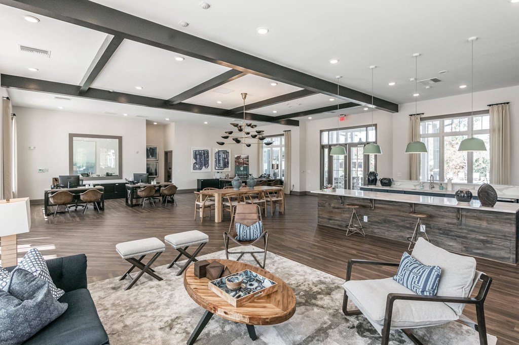 a living room with furniture and a bar and a dining room at Village at Westland Cove Apartments, Knoxville