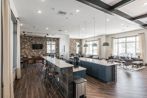 a large kitchen with a bar and a living room at Village at Westland Cove Apartments, Knoxville