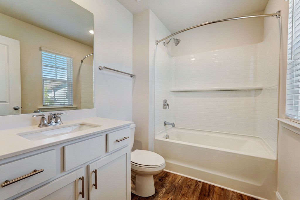 a bathroom with a sink toilet and a bath tub