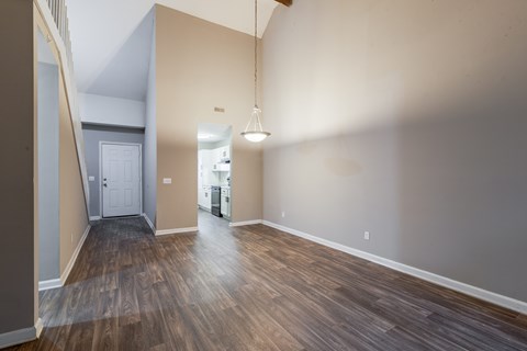 A room with wooden floors and a white door.