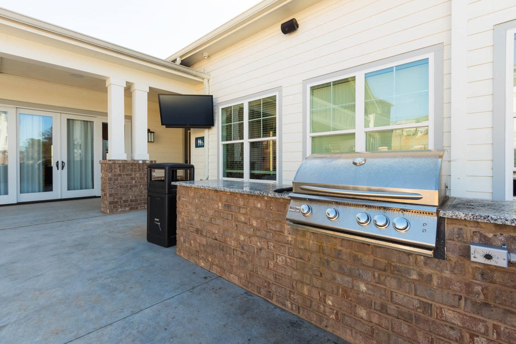 a covered patio with a barbecue grill on it at Capstone at Banks Crossing, Commerce, GA, 30529