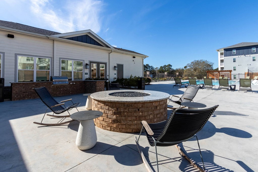 our patio has a fire pit and seating area with chairs and tables at Capstone at Banks Crossing, Commerce, 30529