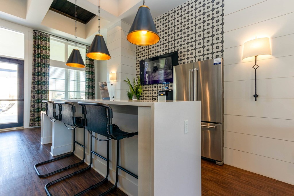 a kitchen with a bar and a stainless steel refrigerator at Capstone at Banks Crossing, Commerce, 30529