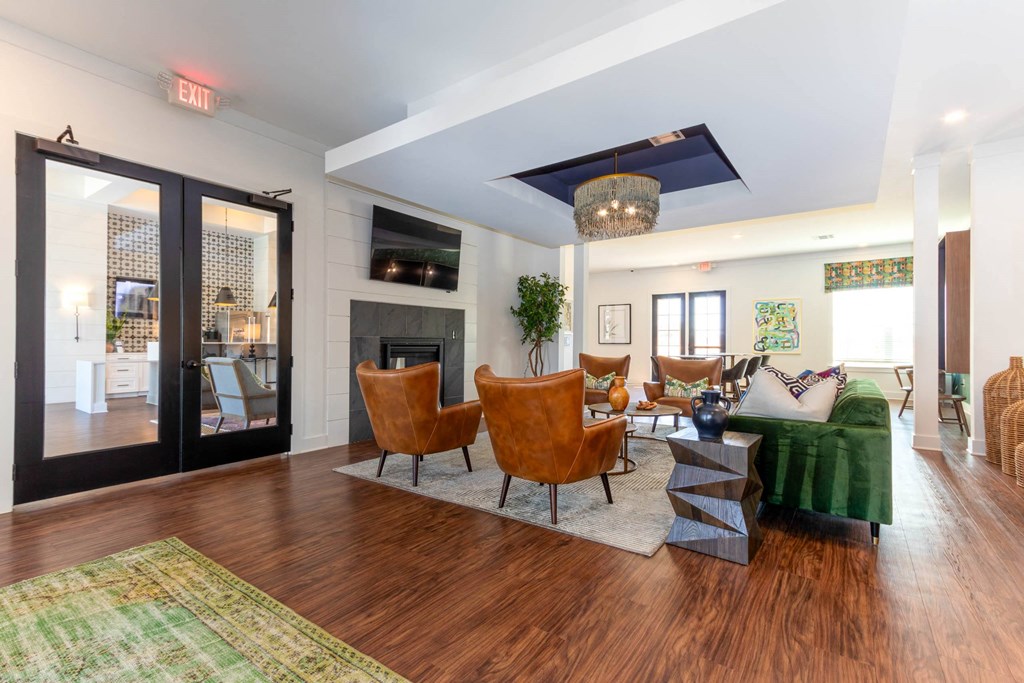 a living room with a fireplace and a green couch at Capstone at Banks Crossing, Georgia