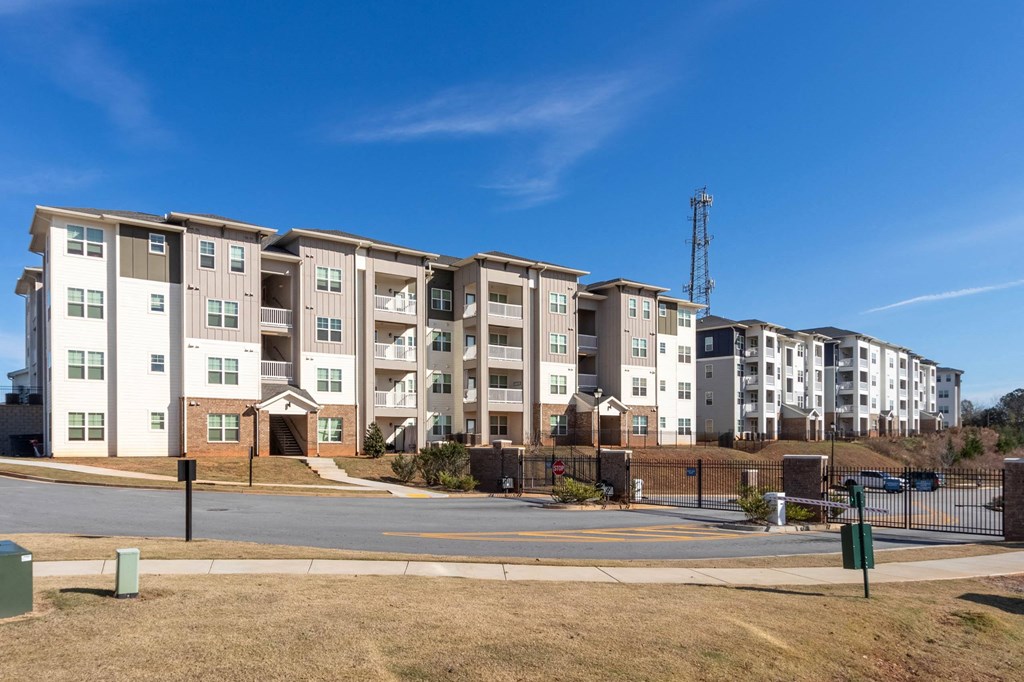 an apartment building on the corner of a street at Capstone at Banks Crossing, Commerce, GA, 30529