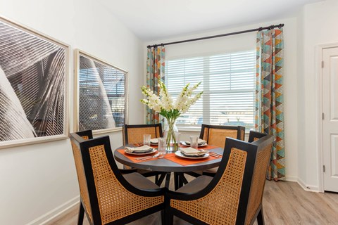 a dining room with a table and chairs and a window at Capstone at Banks Crossing, Commerce, GA
